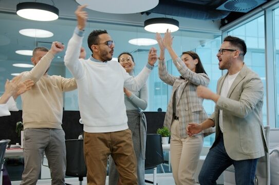 Businesswoman sitting at a laptop smiling at the camera