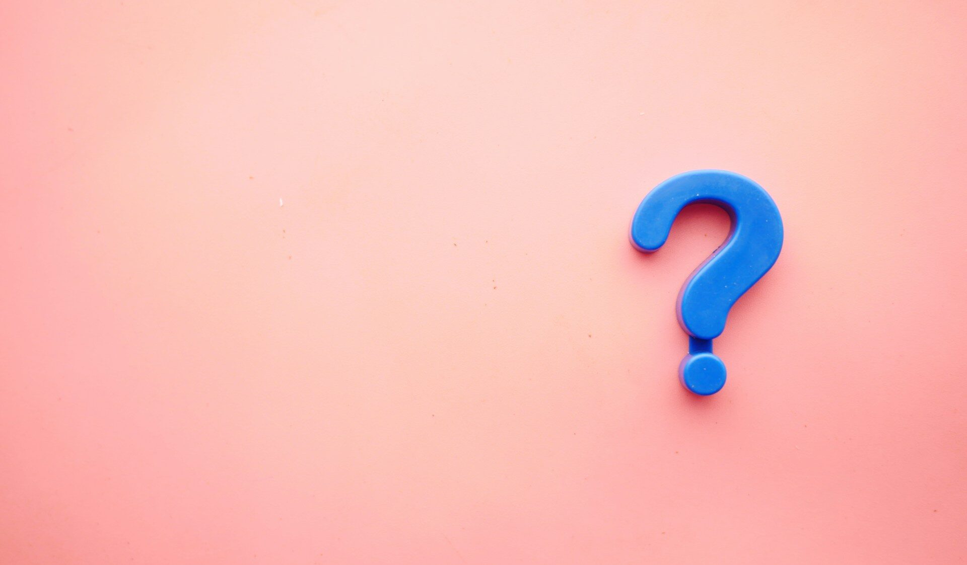 Blue question mark on a bright pink background