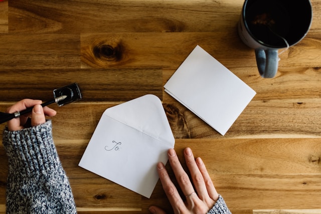 Overhead shot of a person's hand as they address a letter to themselves