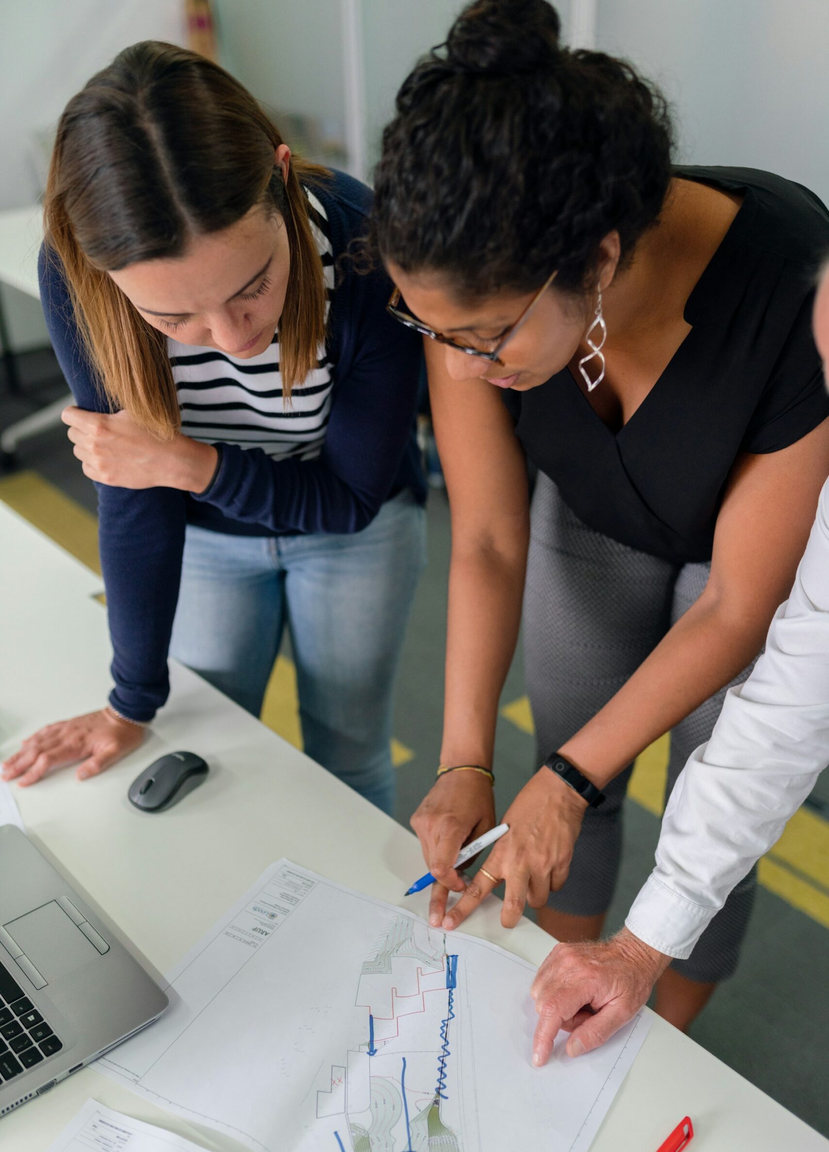 Two coworkers collaborating while hovering over a project