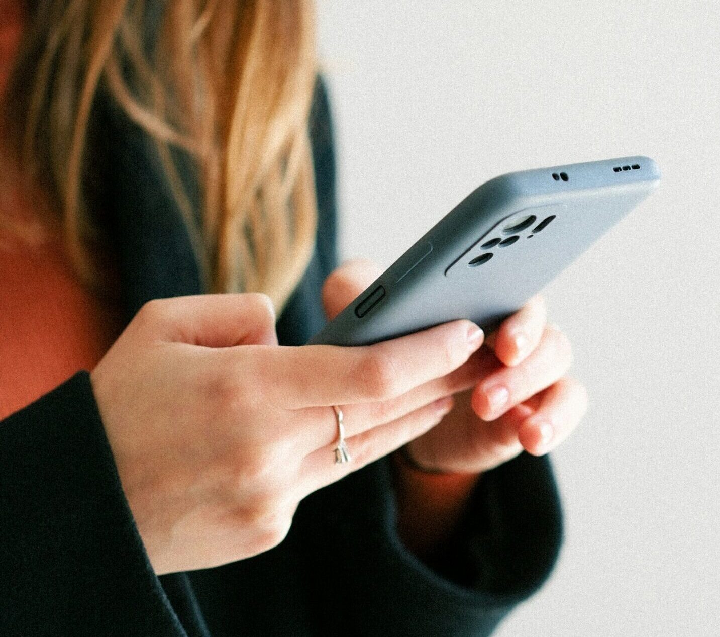 Closeup of a woman holding a cell phone in her hands