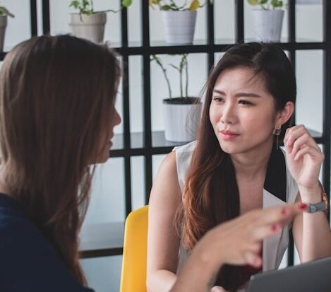 A woman listening intently to another woman speaking